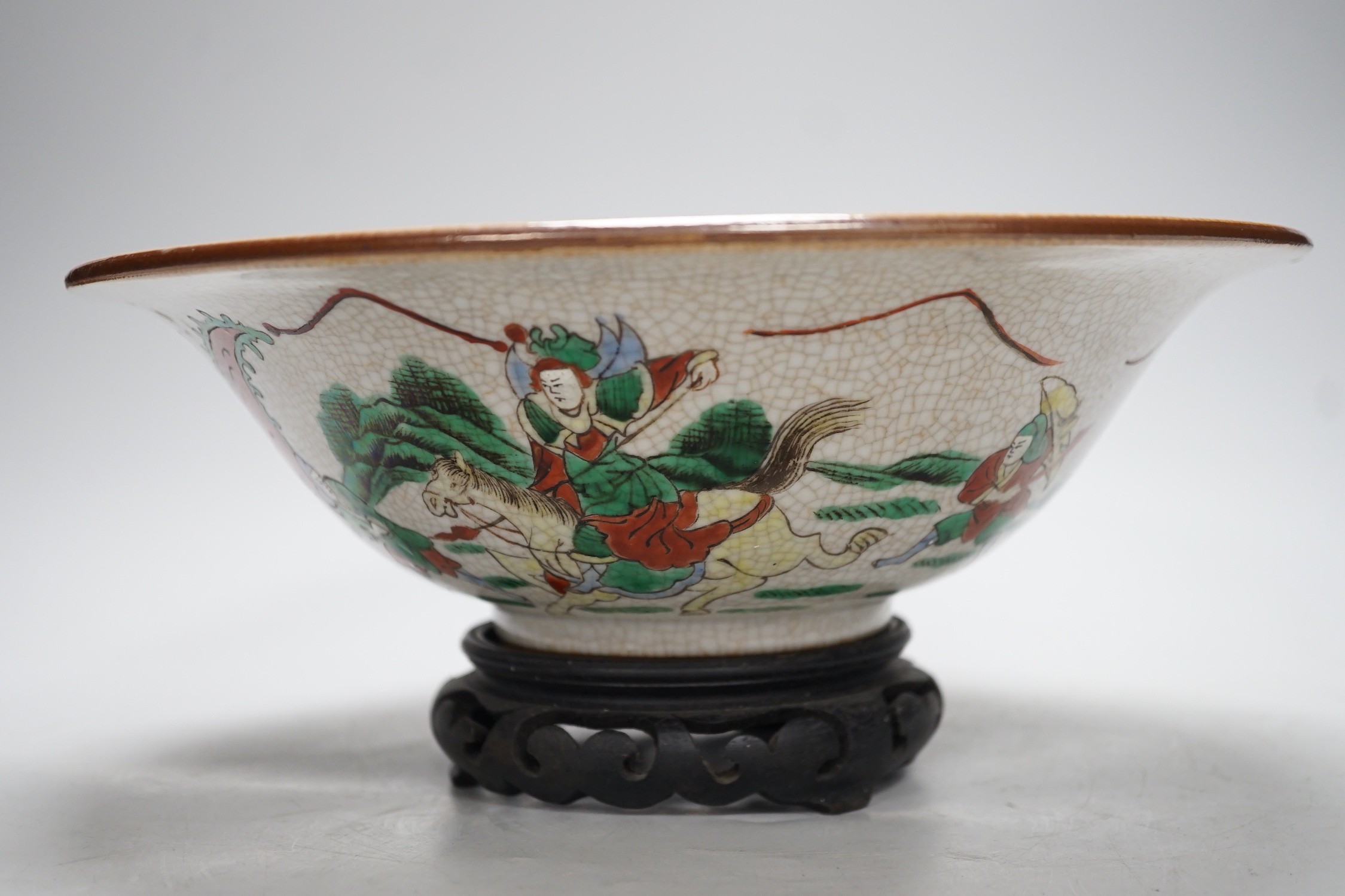 A Chinese famille verte crackle glaze ‘Eight Immortals’ bowl, early 20th century, 29cm diameter, on hardwood stand